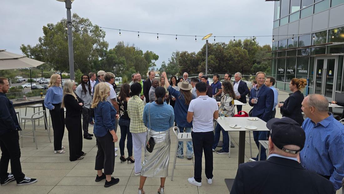Acquicon attendees networking at an outdoor reception